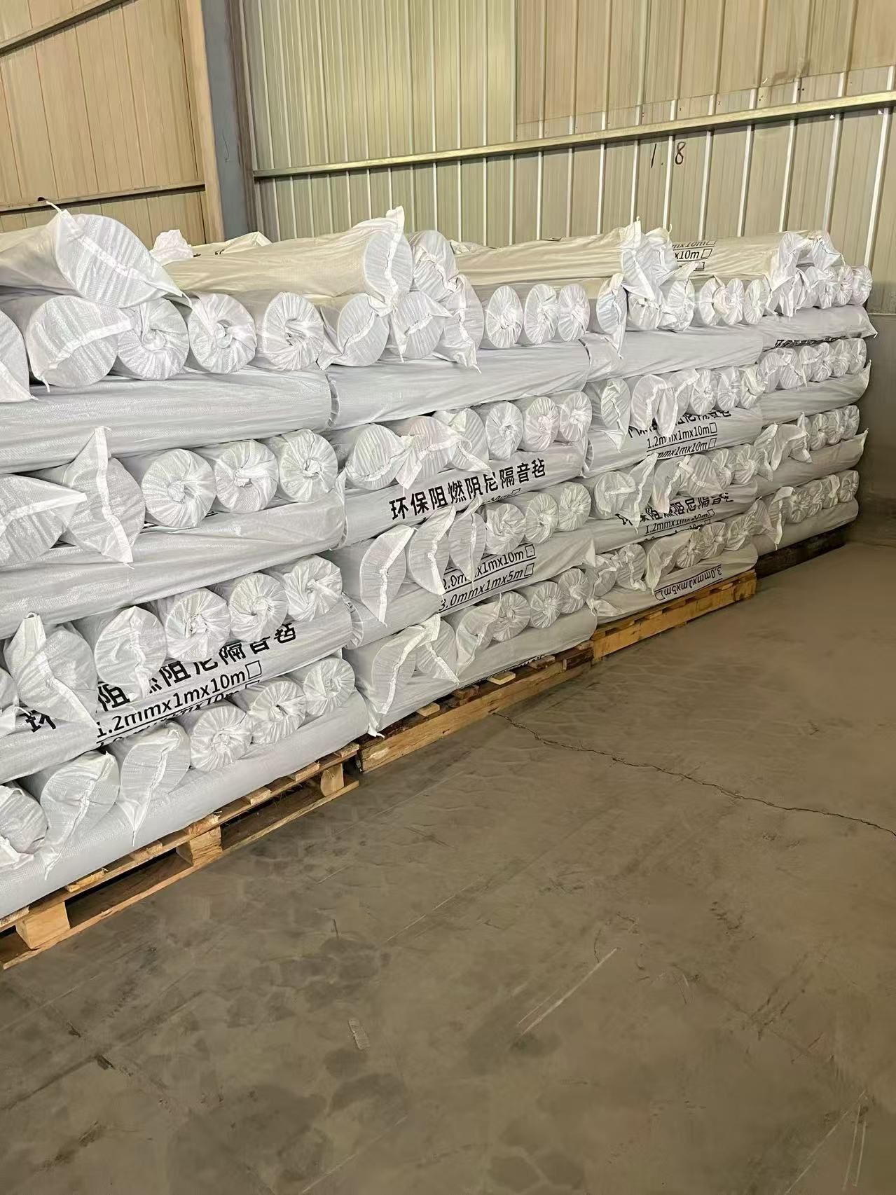 Wrapped MLV rolls stored on pallets before shipment